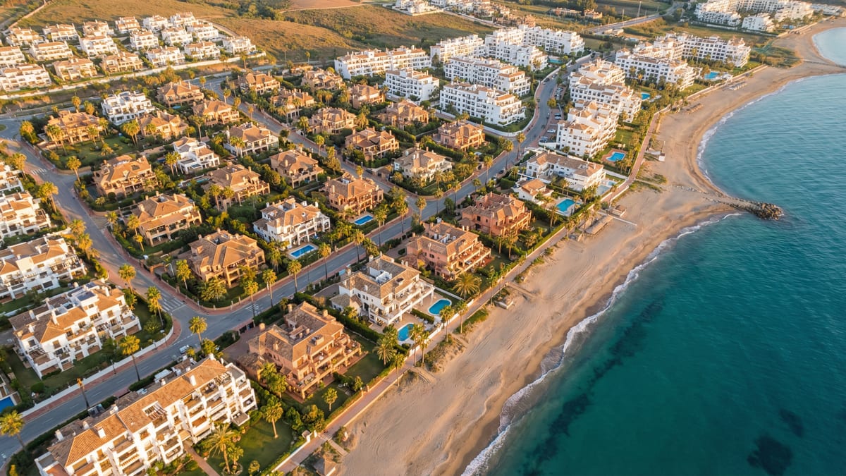 Aerial view of Manilva, Costa del Sol showing Mediterranean coastline, luxury properties, and best areas families opportunities