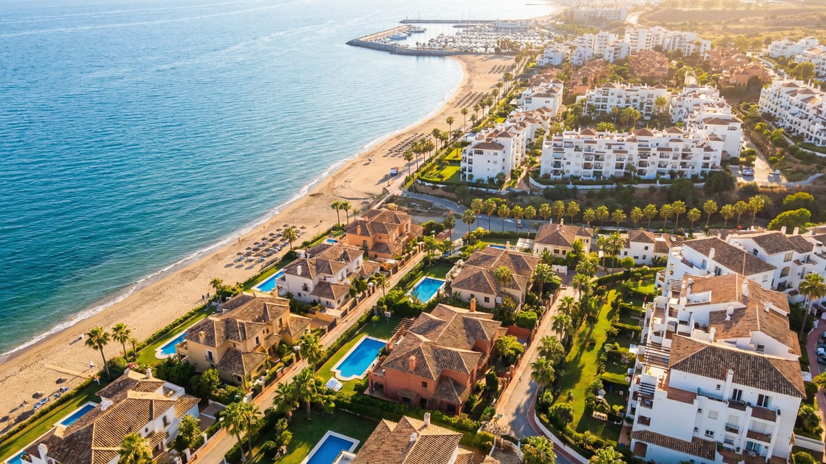 Aerial view of Manilva, Costa del Sol showing Mediterranean coastline, luxury properties, and best areas families opportunities