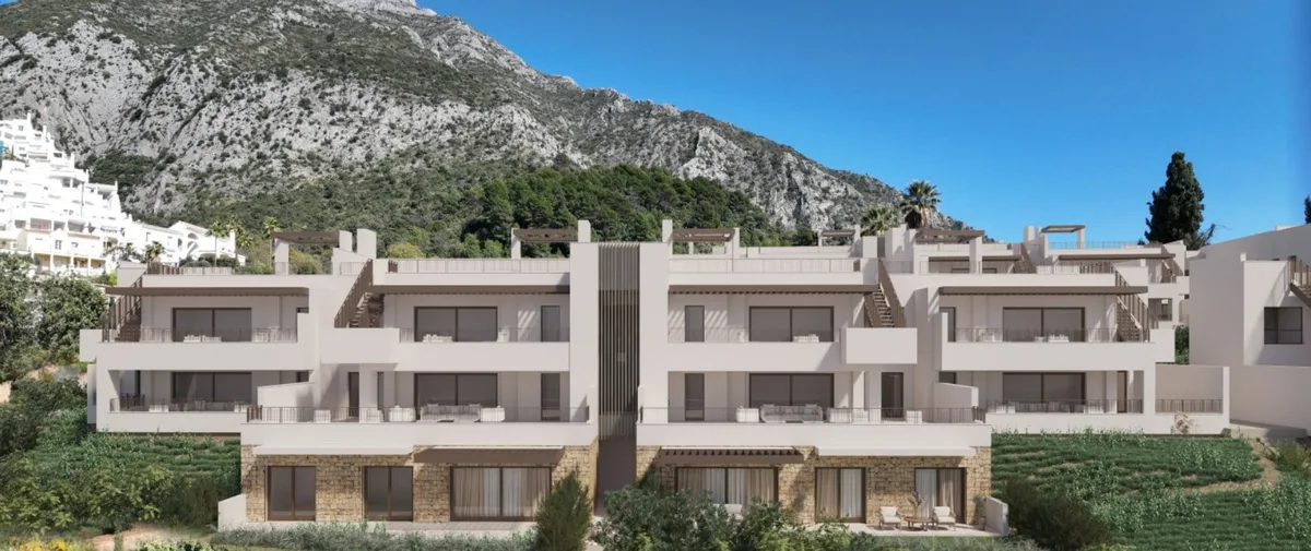 Render of ALMAZARA GARDENS: stepped terraces, light façades and stone-clad lower walls against a mountainous backdrop.