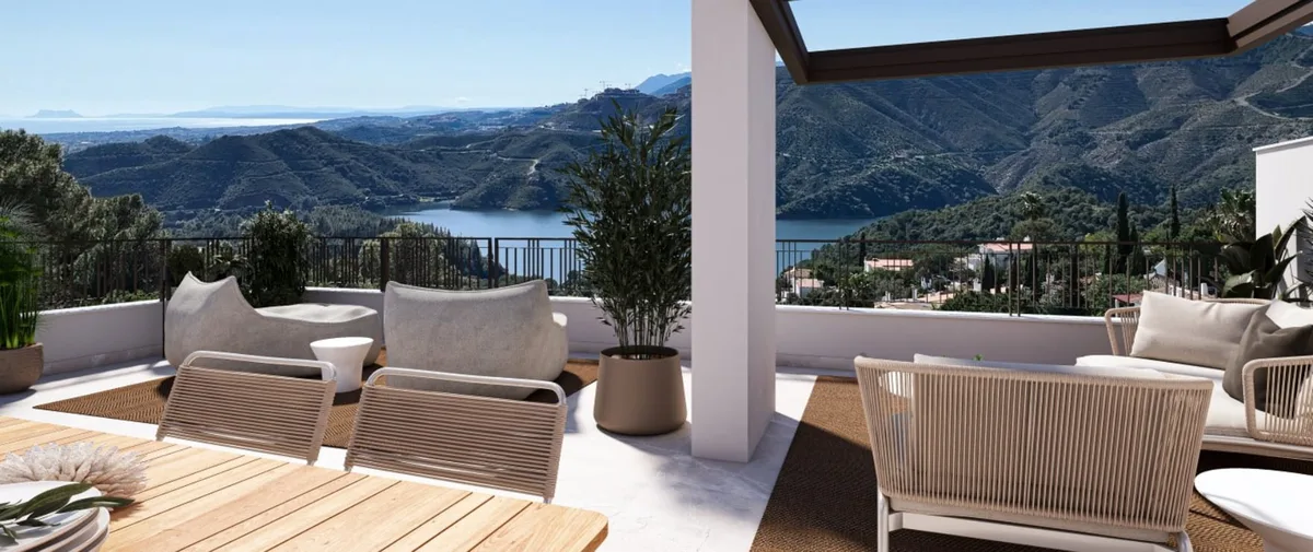 Render of a covered terrace with dining furniture, lounge seating and a reservoir and hills in the distance.