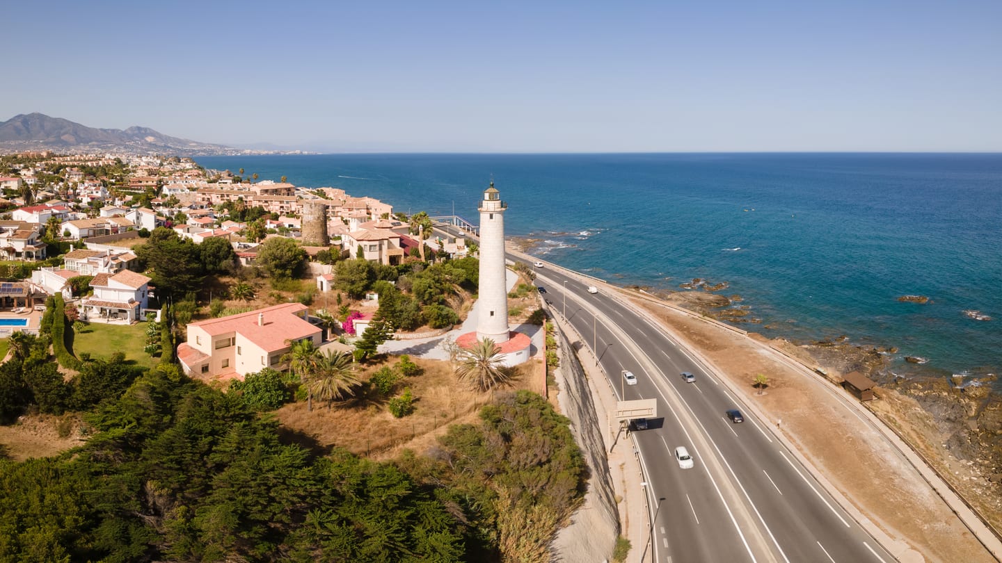 Area photograph near ALTOS DEL CHAPARRAL showing an aerial view of Faro de Calaburras lighthouse and the Mijas Costa Mediterranean shoreline
