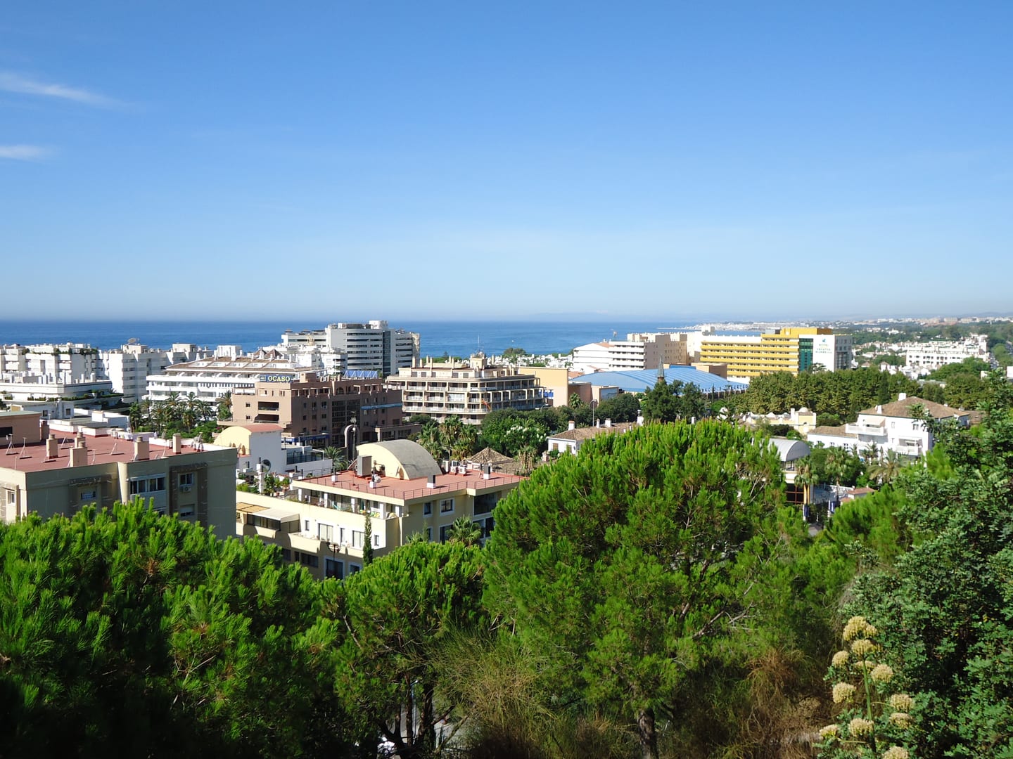Elevated panoramic view across Marbella's urban area toward the Mediterranean Sea, shown as local context near VILLA IVORY
