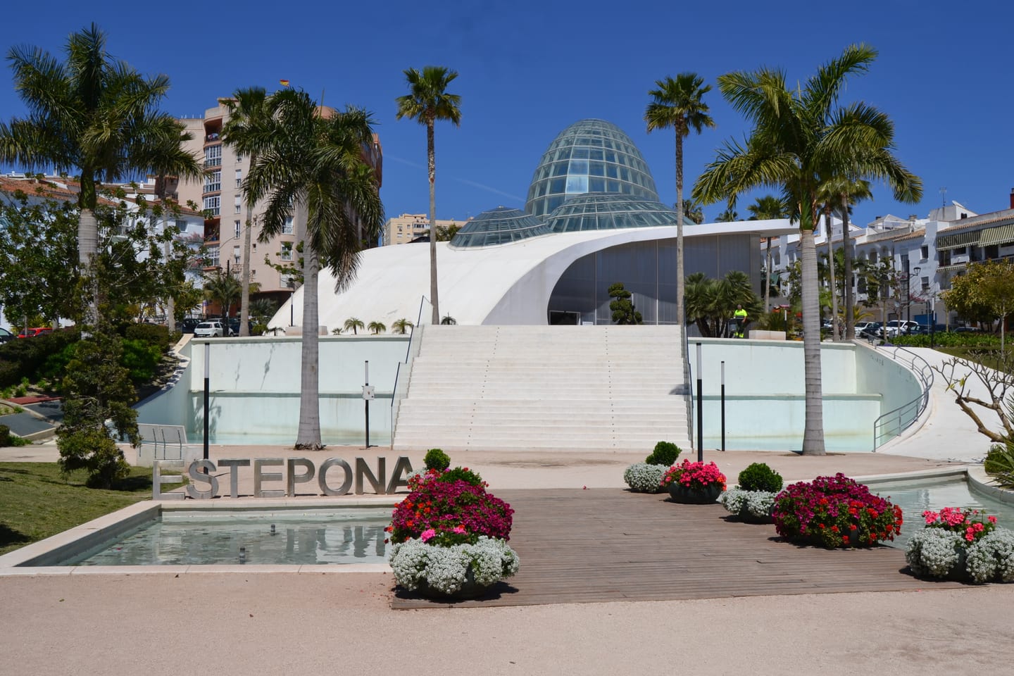GREEN MOUNTAIN 1 area photograph of the Estepona Orchidarium exterior with glass dome, palm trees, ornamental gardens and reflecting pool