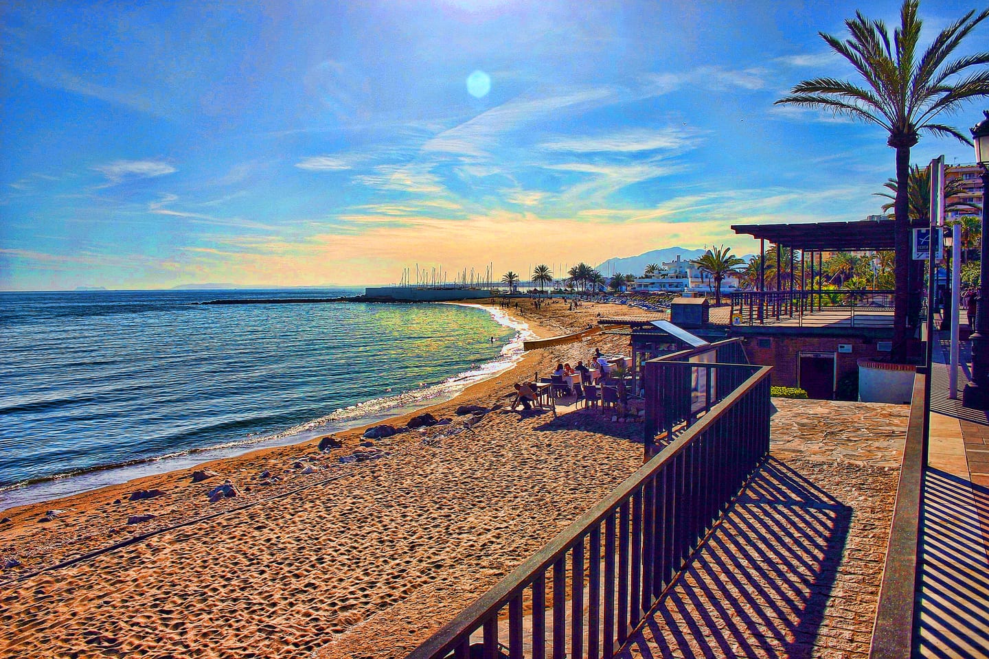 ORIGIN area photograph of Marbella beachfront promenade and Mediterranean shoreline with marina in background
