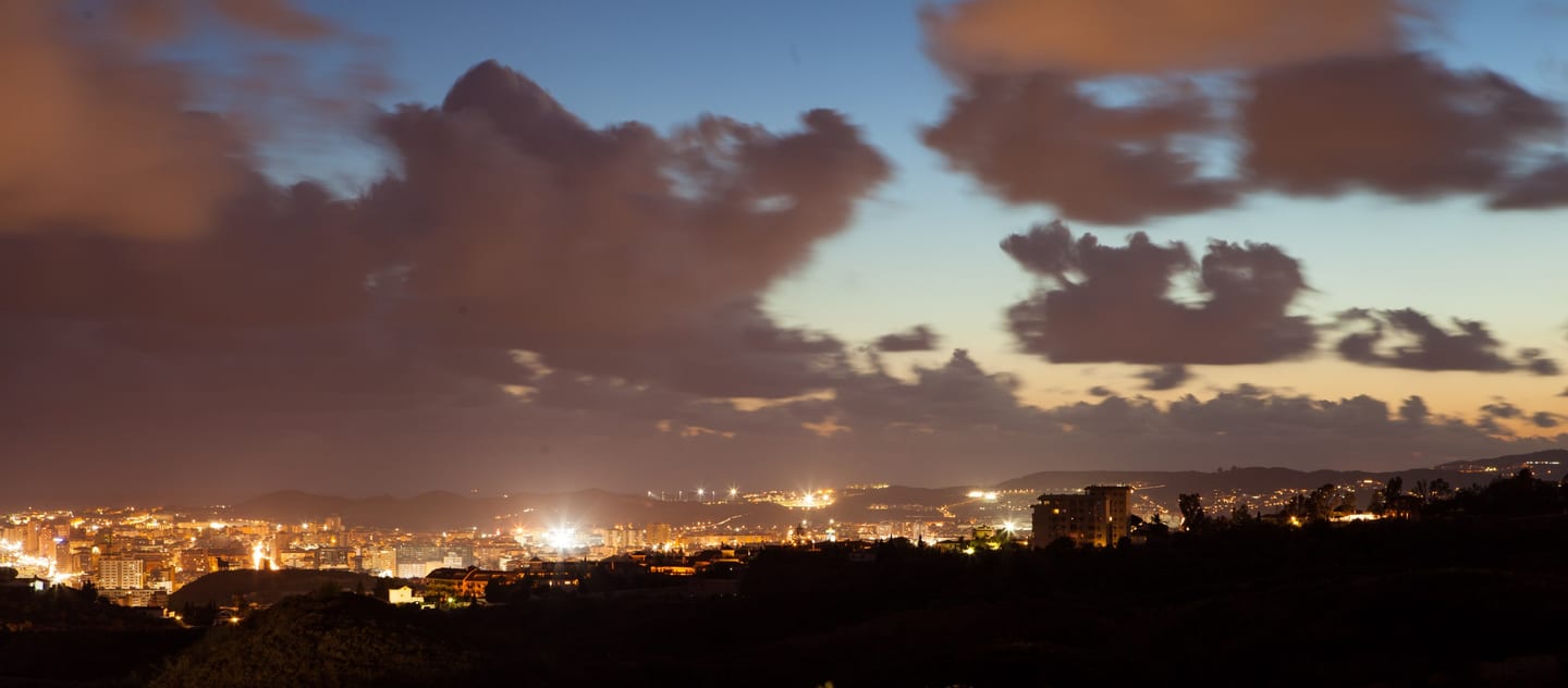 Night-time panoramic view of Fuengirola and surrounding hills, Costa del Sol, Spain, shown as local context near STUPA - VILLA METTA