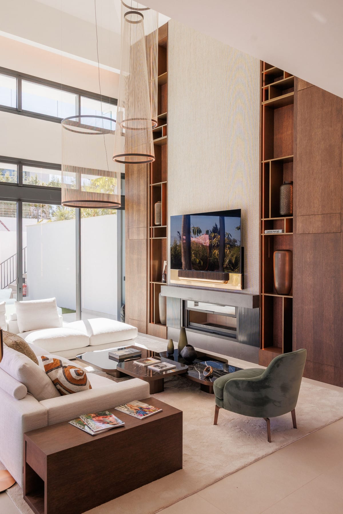 4OUR Villas: living room with fireplace, television and tall wooden cabinets.