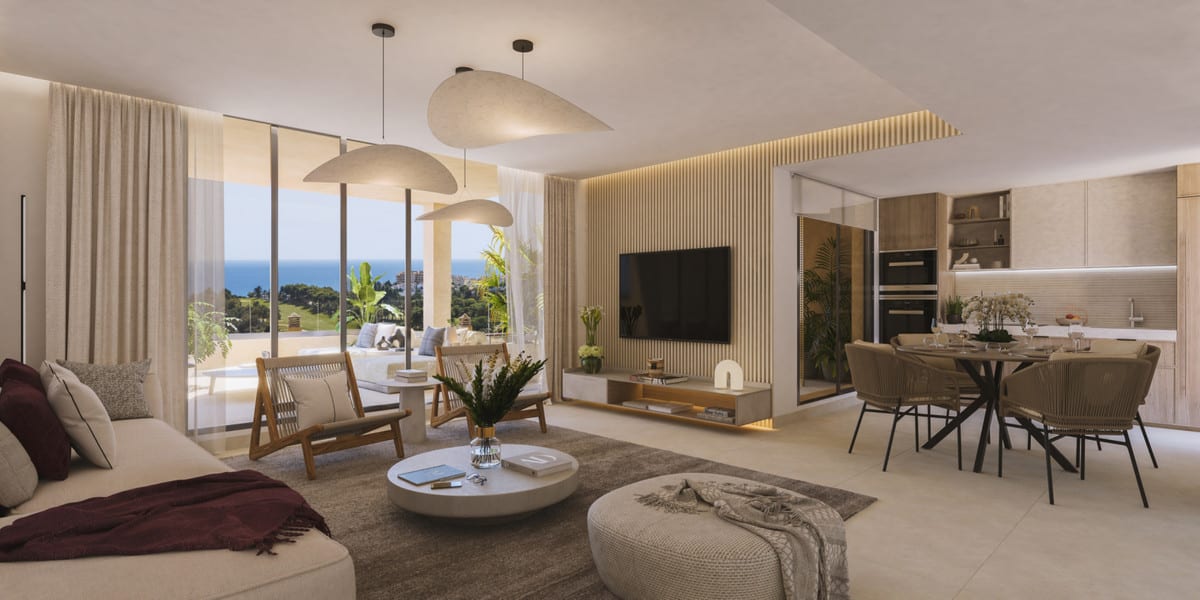 Project visualisation of the living room at ABELIAS with a fabric sofa, armchairs, round coffee table, TV wall, dining table and open kitchen.