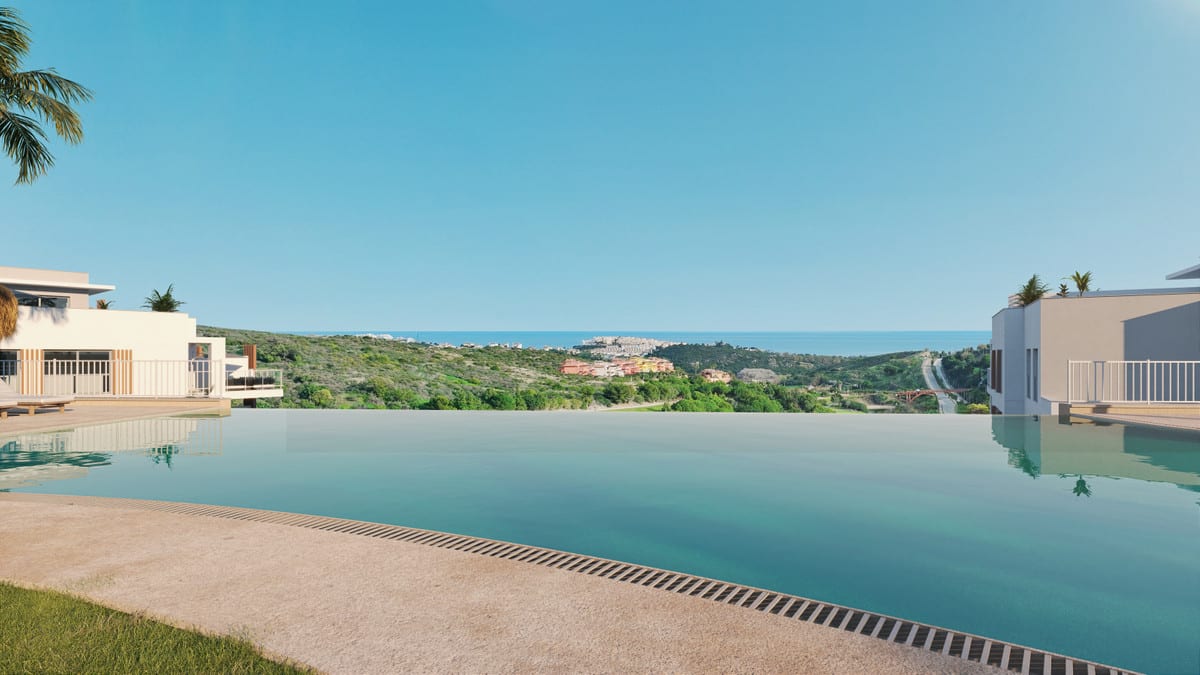 Project visualisation of ABRIL DOÑA JULIA with an infinity pool in the foreground, white building sections on either side, a green hilly landscape with buildings in the middle distance and the sea on the horizon.