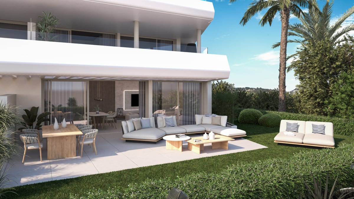 Rendered visualisation of ABSOLUTE ESTEPONA with a covered terrace, wooden dining table with chairs, light lounge seating and a green lawn with a palm tree.