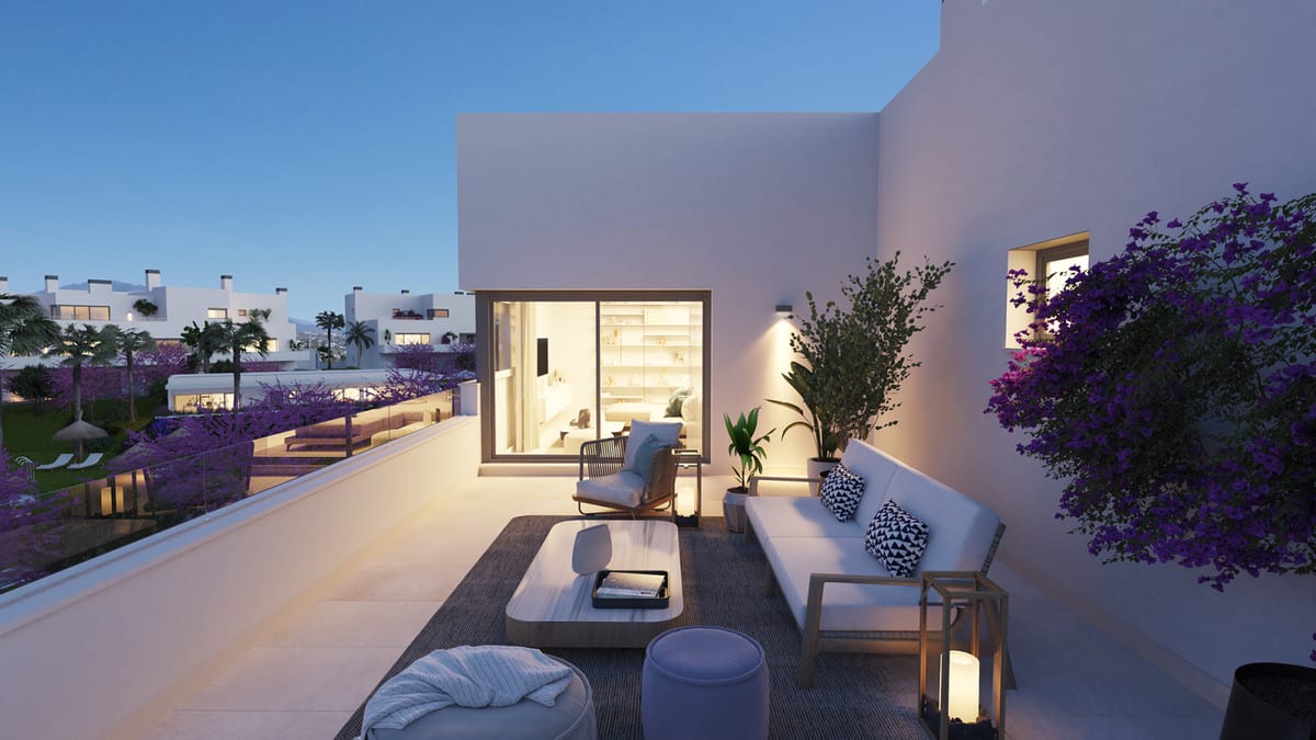 Evening visualisation of ACQUA GARDENS featuring a terrace with a white lounge sofa, armchair, coffee table, lantern, pouffe and bougainvillea beside illuminated glass sliding doors.
