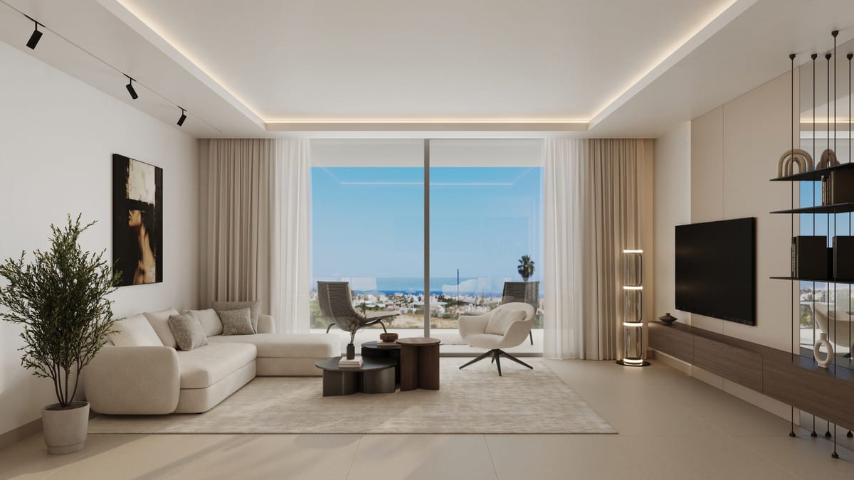 Project visualisation of ALCANTARA DEL MAR APARTMENTS showing a furnished living room with a cream corner sofa, two freestanding chairs, dark coffee tables, wall shelving with a television, indirect ceiling lighting and a large sliding glass door overlooking buildings and blue sky.