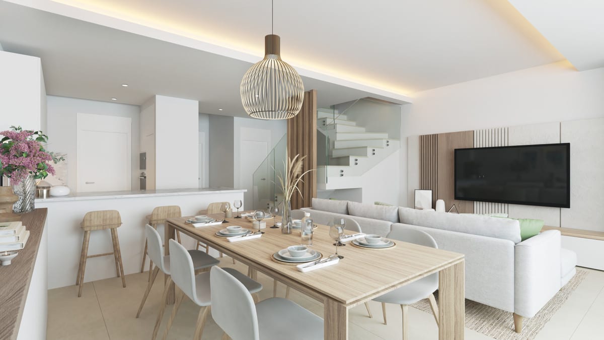 Project visualisation of ALEXANDRA'S DREAM featuring a wooden dining table, open kitchen bar, sofa, wall-mounted television and staircase with a glass balustrade.