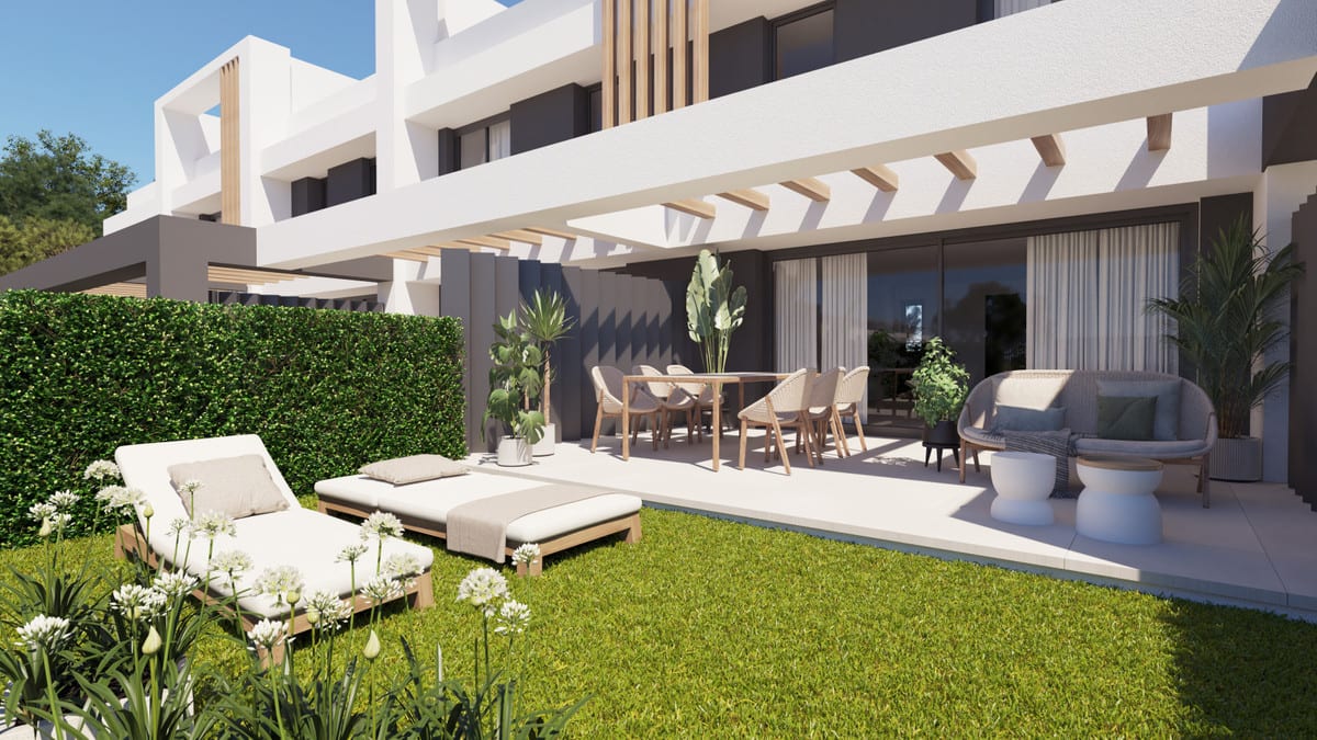 Project visualisation of ALEXANDRA'S DREAM featuring a covered terrace, dining table, seating area and sun loungers on the lawn in front of the white-grey façade.