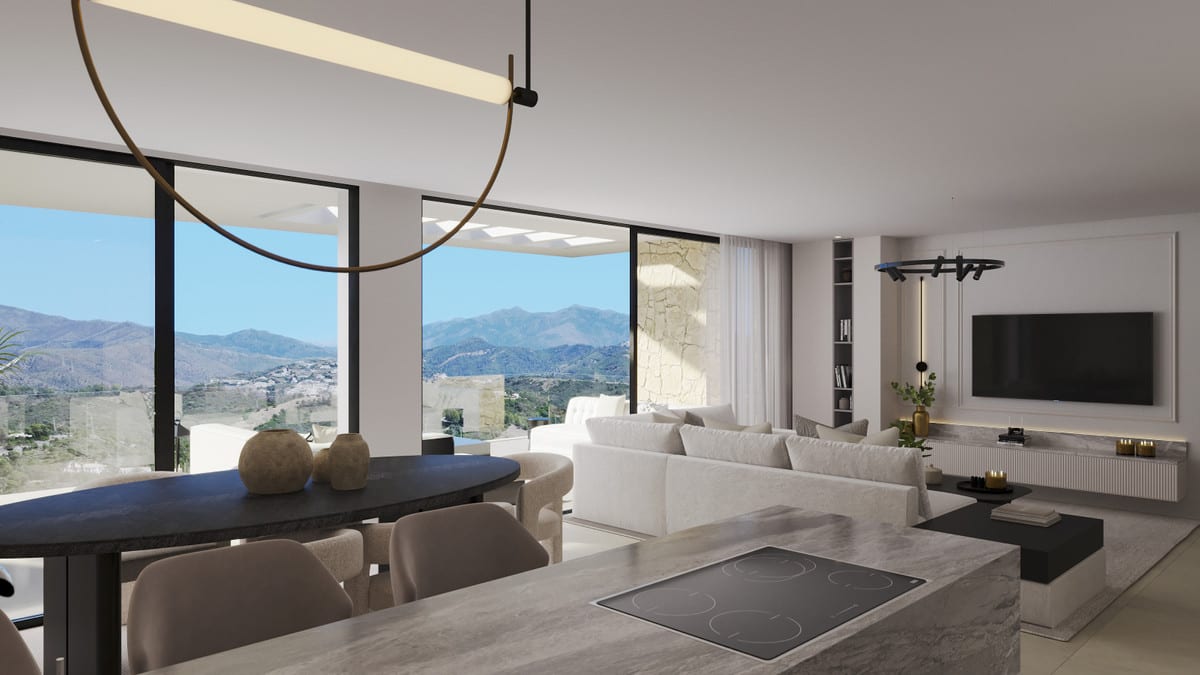 Development visualisation of ALTEZZA SUITES with a marble kitchen island with induction hob in the foreground, dark oval dining table, large black-framed windows with mountain views, light sofa and wall-mounted television.