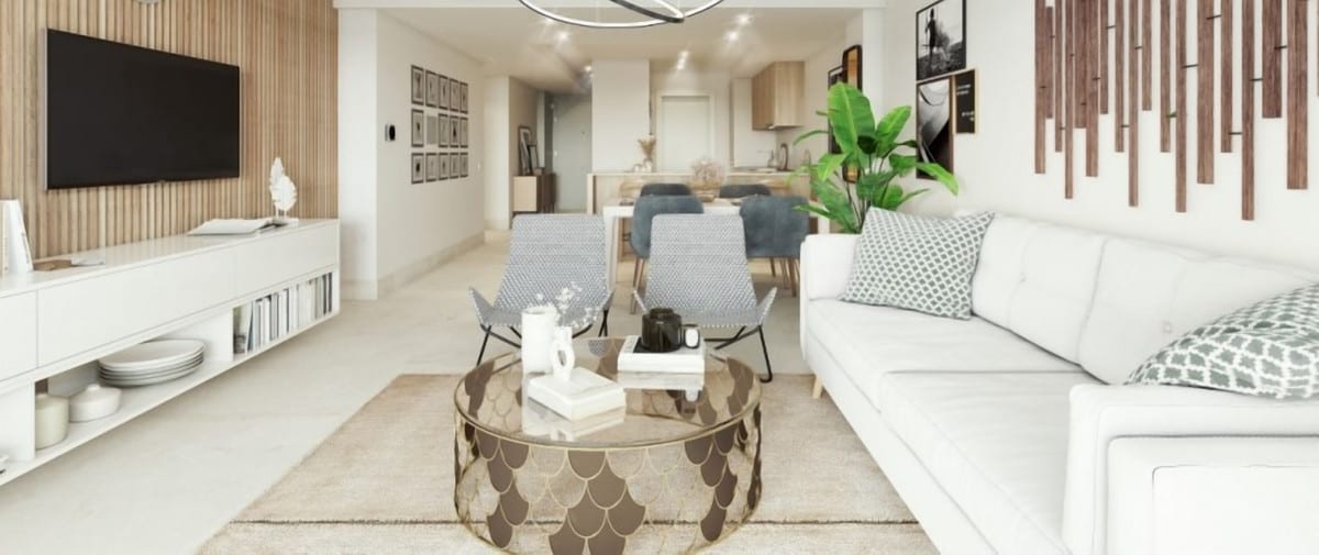 Rendered interior visualisation of ALTURA 160 with a white sofa, two grey armchairs, a round gold-coloured coffee table, a white TV unit with a wooden slatted feature wall, and a dining area with grey-blue chairs in the background.
