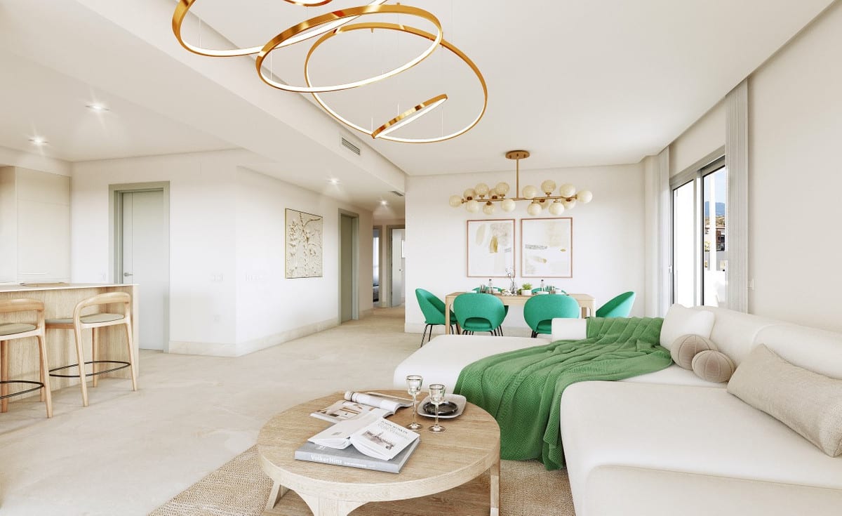 Rendered interior visualisation of ALTURA 160 with a white curved sofa with a green throw, a round wooden coffee table, a gold sculptural ring chandelier, green dining chairs around a wooden table and a kitchen bar with wooden stools.
