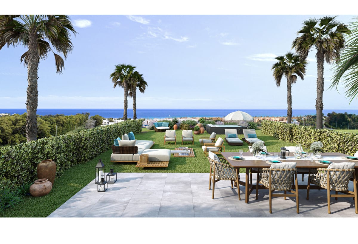 Rendered project visualisation of ALURA LIVING with a tiled terrace, wooden dining table with woven chairs, lawn, lounge furniture, sun loungers, palm trees and sea views in the background.