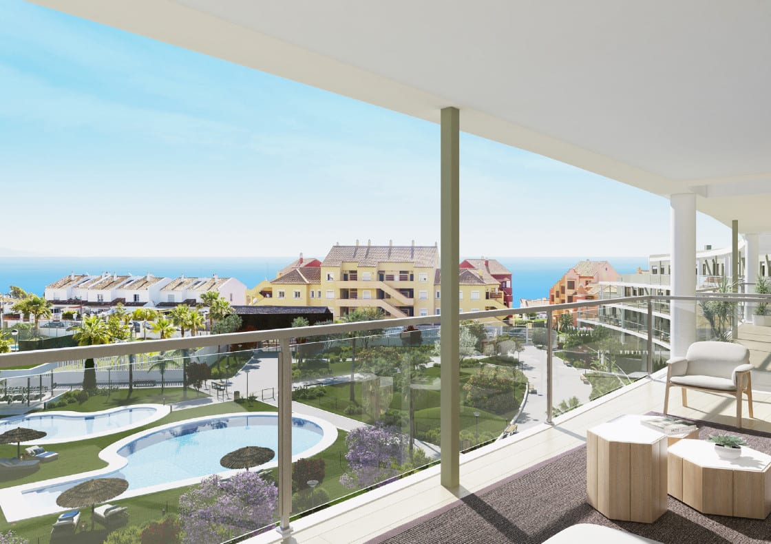 Project visualisation of AMPHORA BEACH FASE III seen from a covered terrace with a glass balustrade, chair and side table, overlooking a swimming pool, gardens, surrounding buildings and the sea.