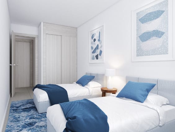 Project visualisation of a bedroom at AMPHORA BEACH FASE III with two single beds, blue bedding, a bedside table with lamp and a built-in wardrobe.