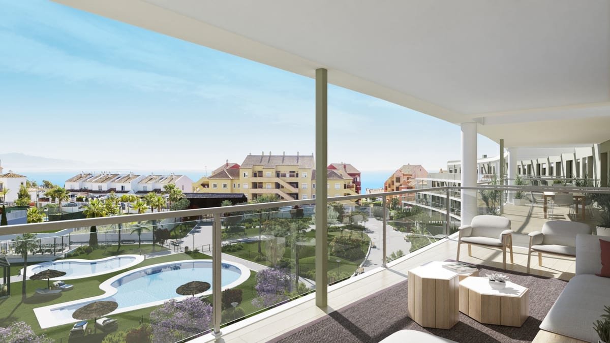 Project visualisation of the covered terrace at AMPHORA BEACH FASE IV with a glass balustrade, seating and views of the swimming pools, surrounding buildings and the sea on the horizon.