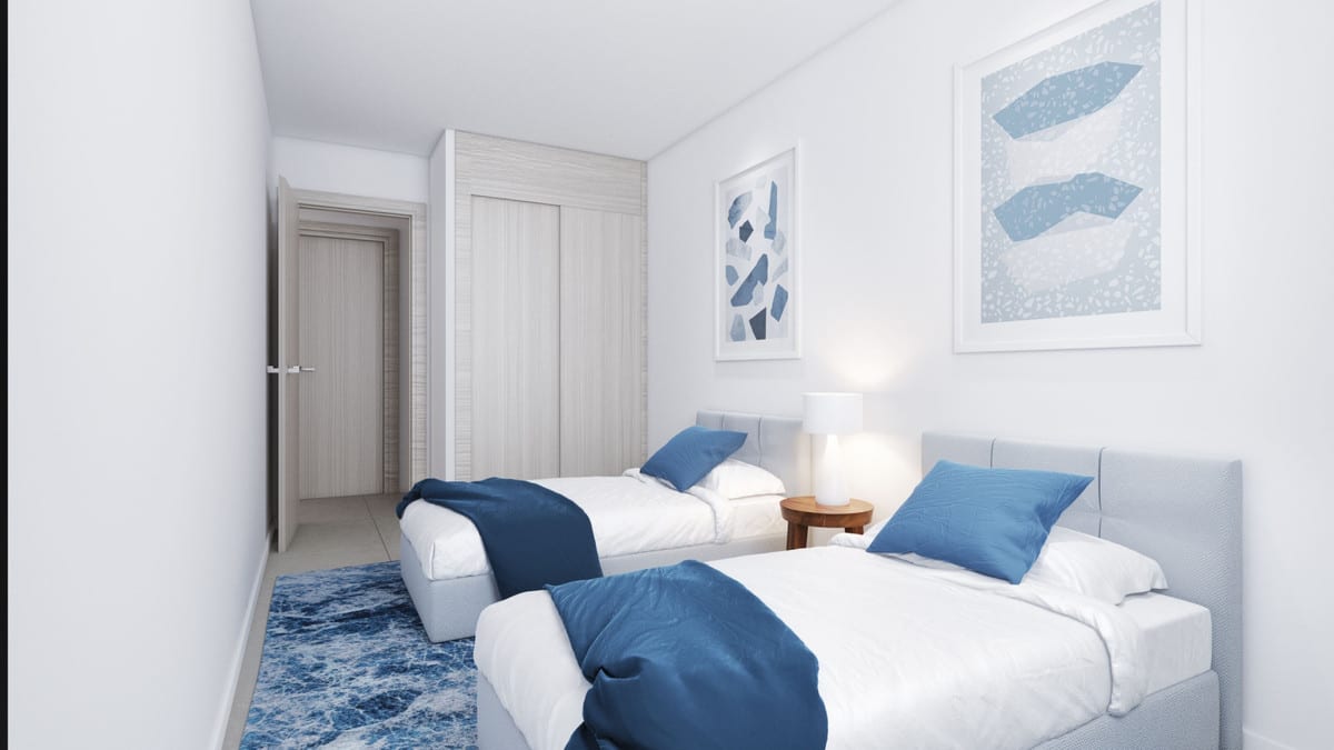 Project visualisation of a bedroom at AMPHORA BEACH FASE IV with two single beds, blue bedspreads and cushions, a blue rug and a fitted wardrobe.