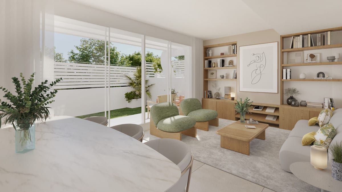 Development visualisation of ANNA DE ESTEPONA with a living room, marble-effect tabletop in the foreground, two rounded green armchairs, a wooden coffee table and a wooden wall unit with open shelves.