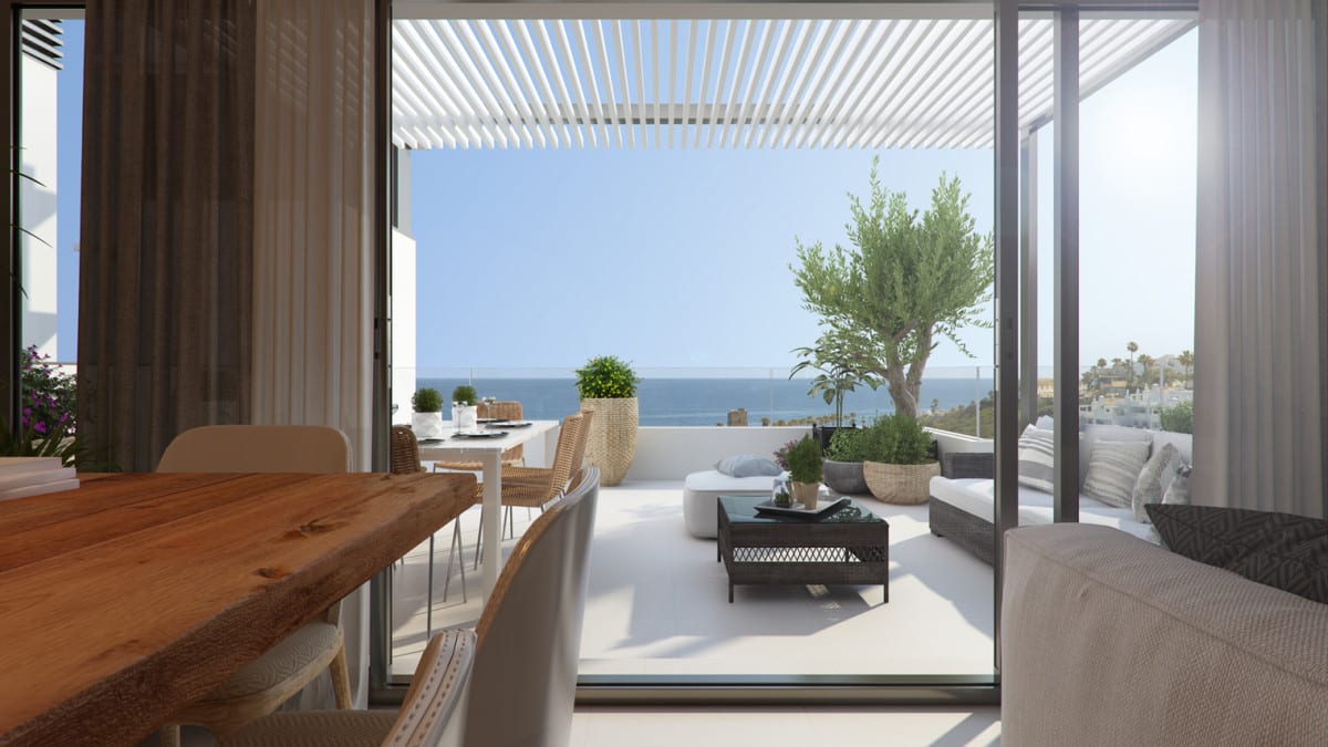 Project visualisation of ARRECIFE featuring a wooden dining table indoors, large glass sliding doors and a terrace with a white pergola, lounge area, outdoor dining table and sea views.