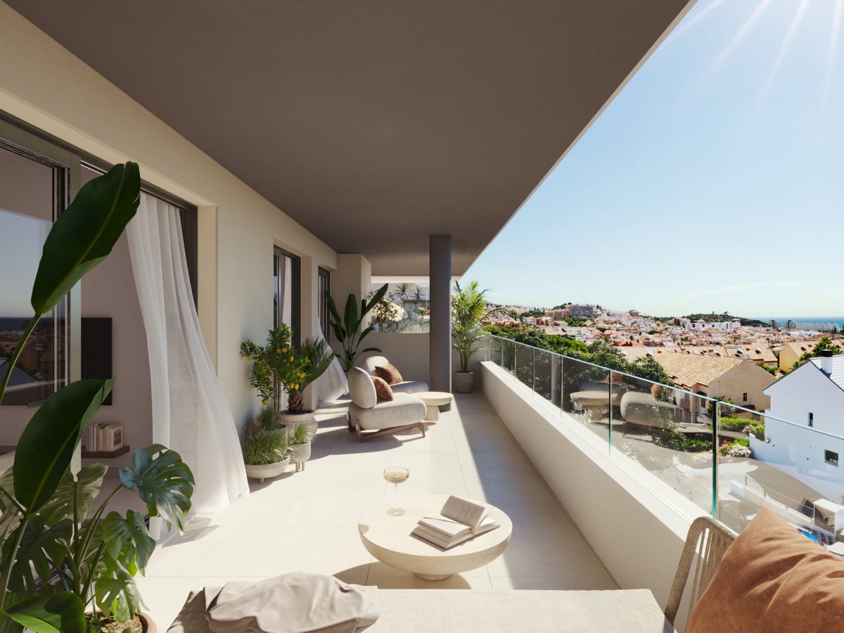 Rendered terrace visualisation of ASTRA HOMES featuring a covered balcony, lounge chair, oval coffee table, various potted plants, white curtains and a glass balustrade overlooking rooftops and surrounding buildings.