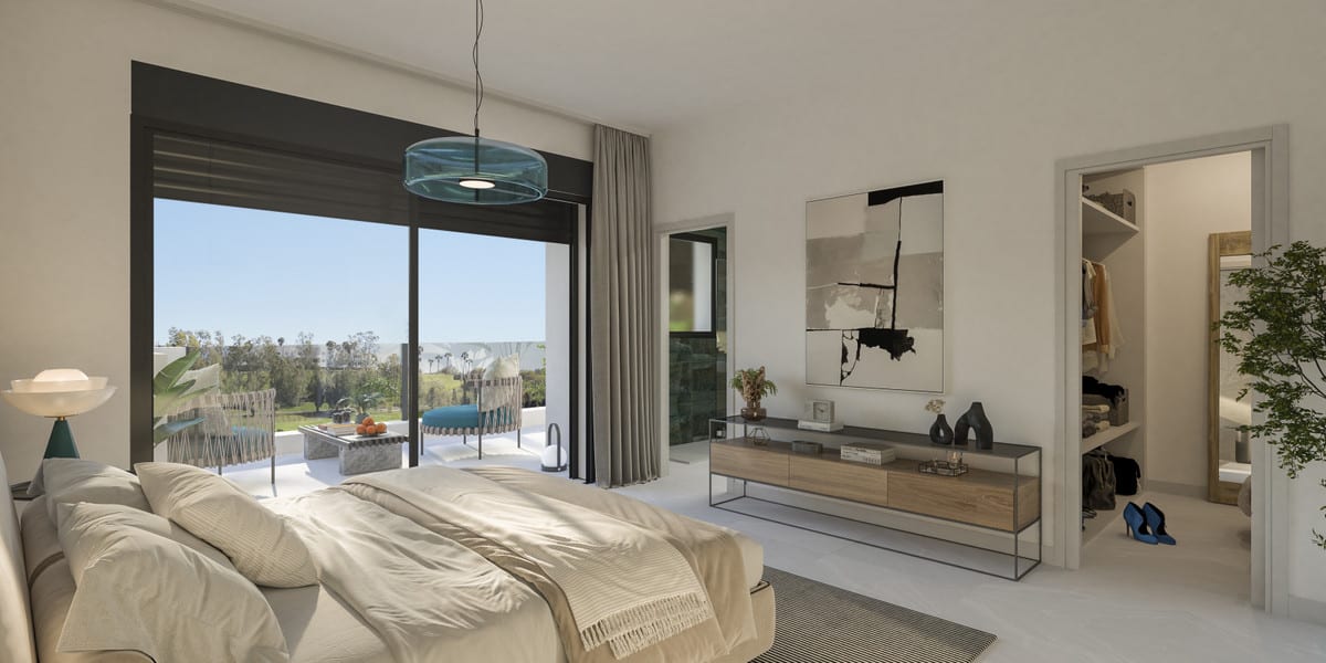 Project visualisation of ATTIRE ESTEPONA featuring a bedroom, double bed, teal pendant light, large sliding glass door to a terrace with outdoor chairs, wooden console table, abstract painting and an open passage to a walk-in wardrobe.