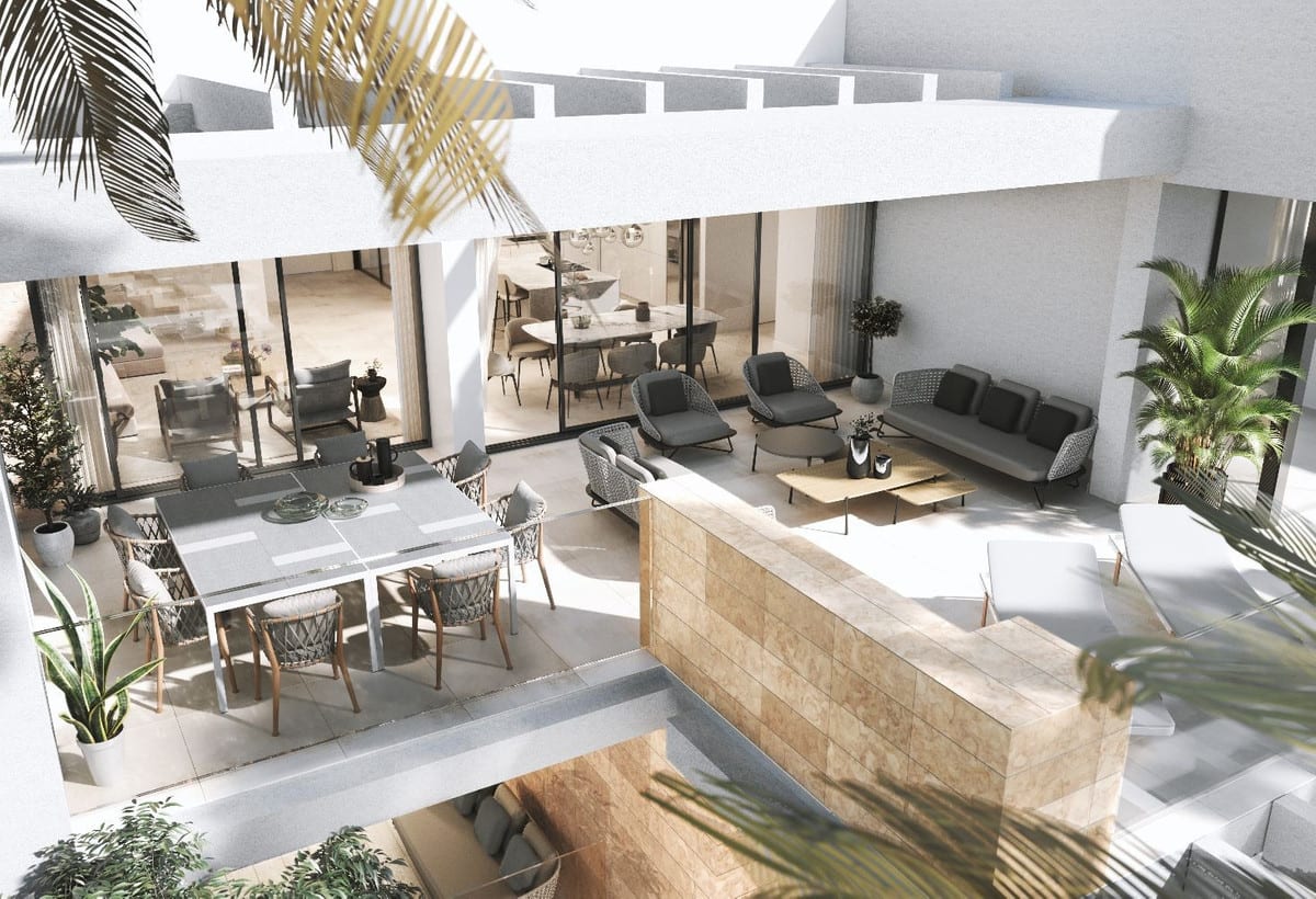 Project visualisation of AYANA ESTEPONA showing a furnished terrace from above, with a dining area, lounge area, potted plants and sliding glass doors leading into the interior.