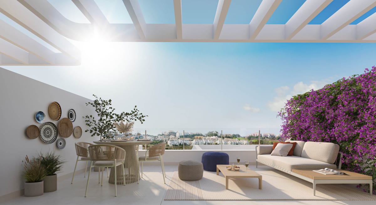 Rendered project visualisation of BAHIA with a spacious terrace beneath an open slatted structure, a round dining table with chairs, a lounge sofa with coffee table, wall decorations and lush purple bougainvillea.