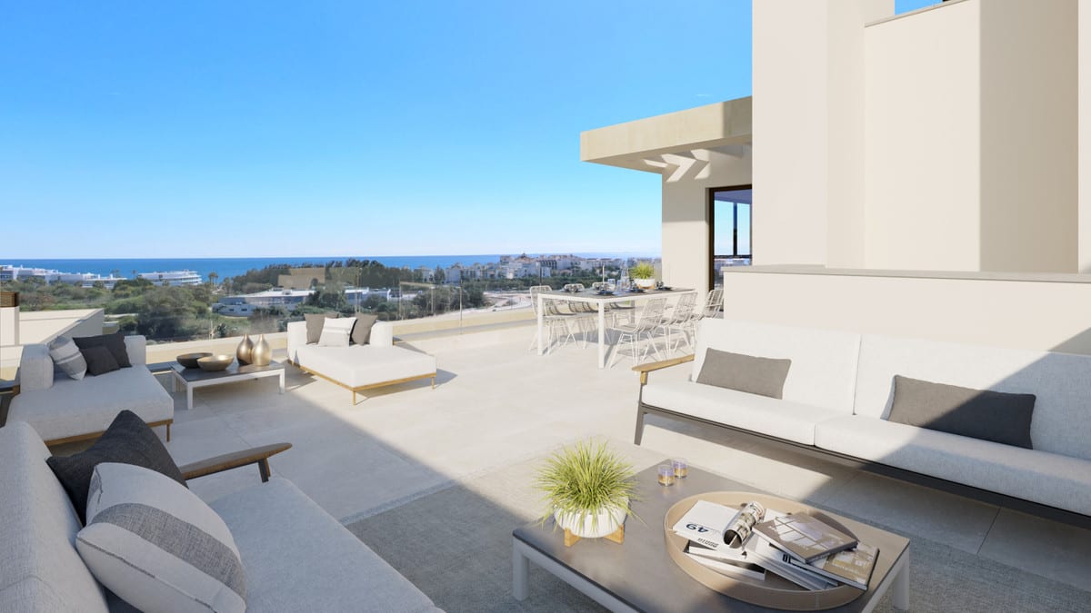 Project visualisation of BAYSIDE HOMES with a spacious terrace, white light outdoor sofas, coffee table, dining table with chairs, glass balustrade and a view of the sea on the horizon in this rendered perspective.
