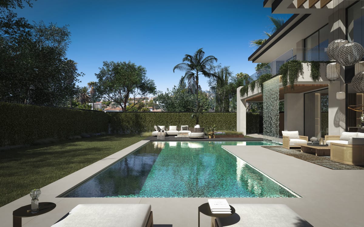 View across the pool towards the garden hedge and the waterfall beside the facade of BE SEVEN.