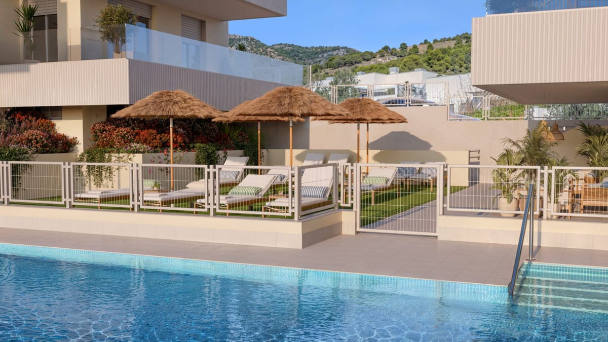 Project visualisation of BLOSSOM HILLS with a swimming pool, sun loungers, thatched parasols and a planted seating area.