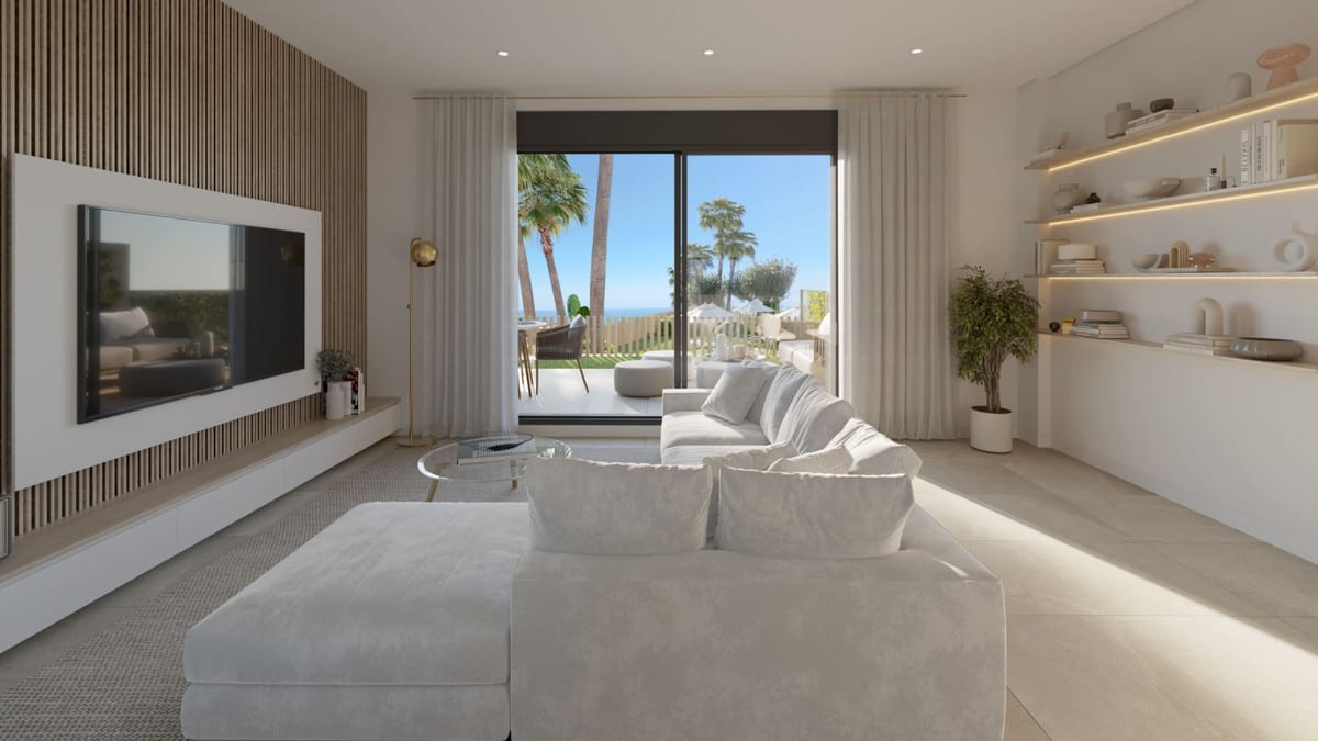 Rendered spacious living room at BLUE WAVE with a white corner sofa, television on a wooden slatted wall, illuminated wall shelving on the right and open sliding doors to a terrace with palm trees and the sea.
