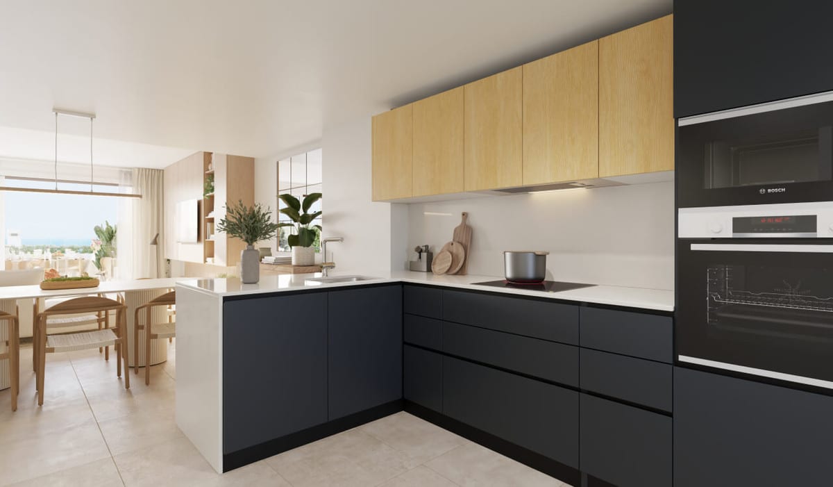 Project visualisation of the CALA SERENA SUN kitchen with dark blue L-shaped base units, light wooden wall units, white worktop, hob and built-in Bosch oven and microwave.