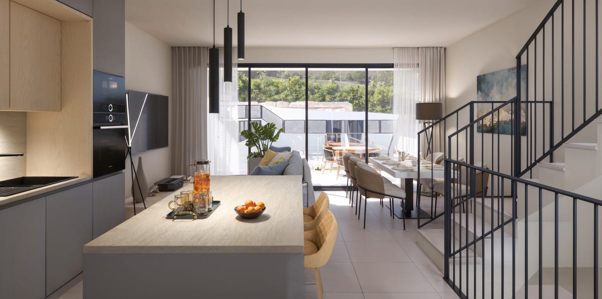 Project visualisation of CALAGOLF BY MARINSA with an open-plan kitchen, light kitchen island, dining table with chairs, black metal staircase and large sliding doors leading outside.