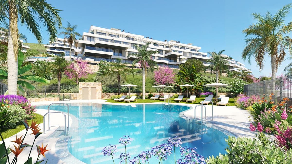 Rendered project visualisation of CALANOVA COLLECTION featuring a curved swimming pool, sun loungers with parasols, palm trees and flowering planting in front of a light-coloured building with terraces.