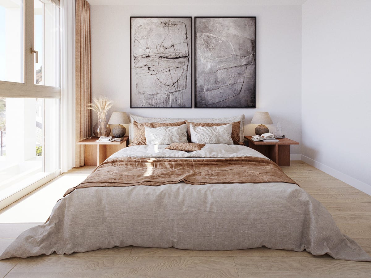 Project visualisation of CALANOVA HOMES featuring a double bed with beige and brown bedding, two wooden bedside tables with lamps, a light wooden floor, two abstract grey artworks in black frames and a window with curtains.