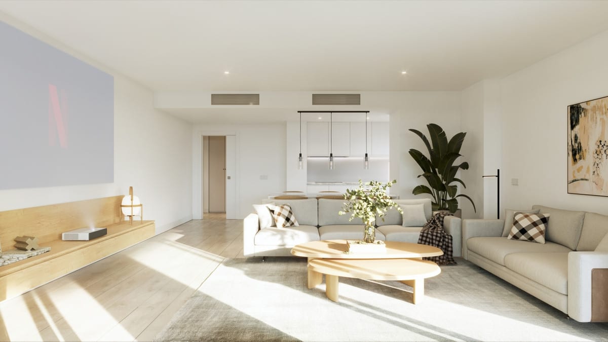 Project visualisation of the living room at CAMARATE HILLS II with two light-coloured sofas, round wooden coffee tables, a low wooden media unit on the left, a projected image on the left wall, framed artwork on the right, a large houseplant and an open-plan kitchen in the background.