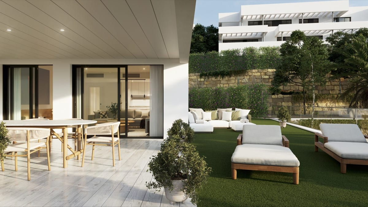 Composite project visualisation of a terrace and garden at CAMARATE HILLS II: on the left, a covered terrace with an oval dining table and woven wooden chairs beside sliding doors; on the right, a lawn with wooden sun loungers, a lounge set, planted stone walls and white buildings in the background.
