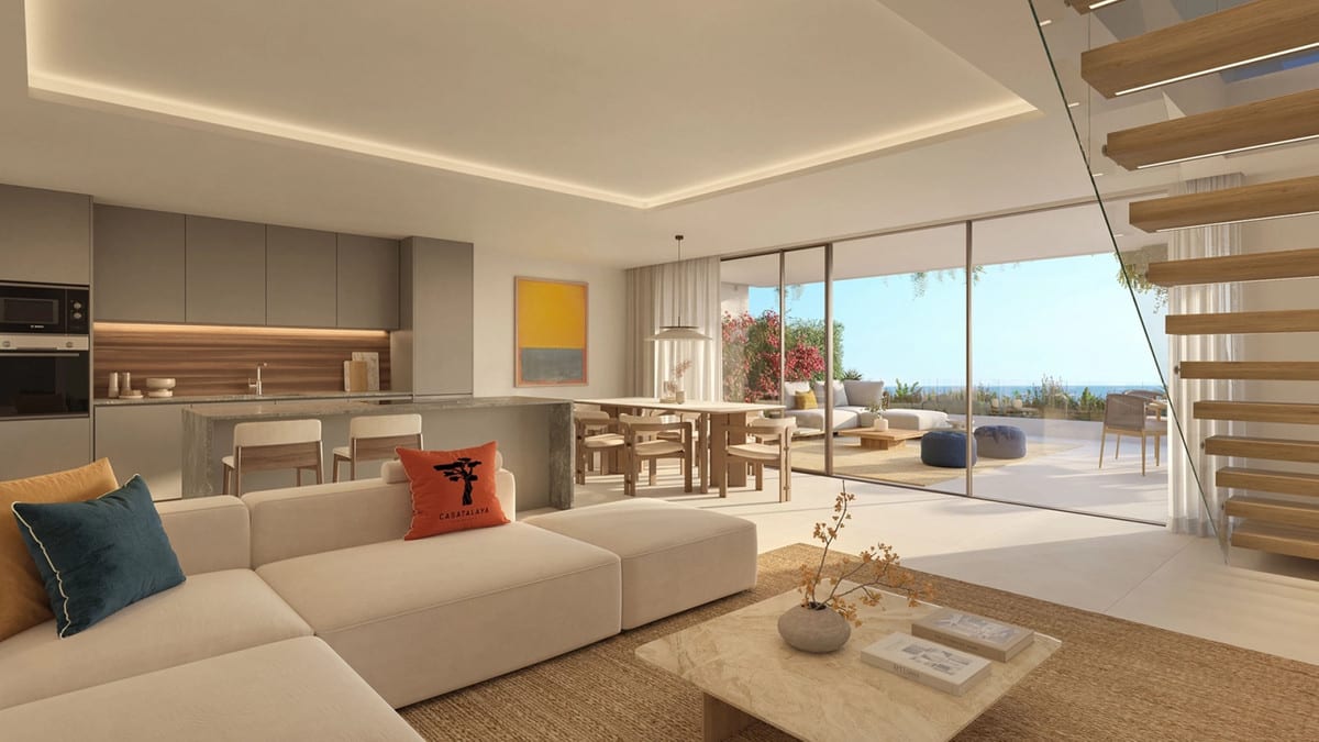 Interior visualisation of CASATALAYA RESIDENCES with a cream corner sofa, grey kitchen with an island and bar stools, dining area, floating wooden staircase with glass balustrade and wide sliding doors leading to a terrace.