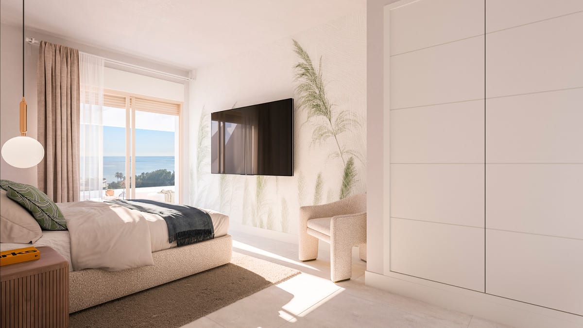 Project visualisation of CELESTIA HOMES with an upholstered bed, wooden slatted bedside table, wall-mounted television, botanical wall motif, armchair, large white fitted wardrobe and sliding doors with sea views.