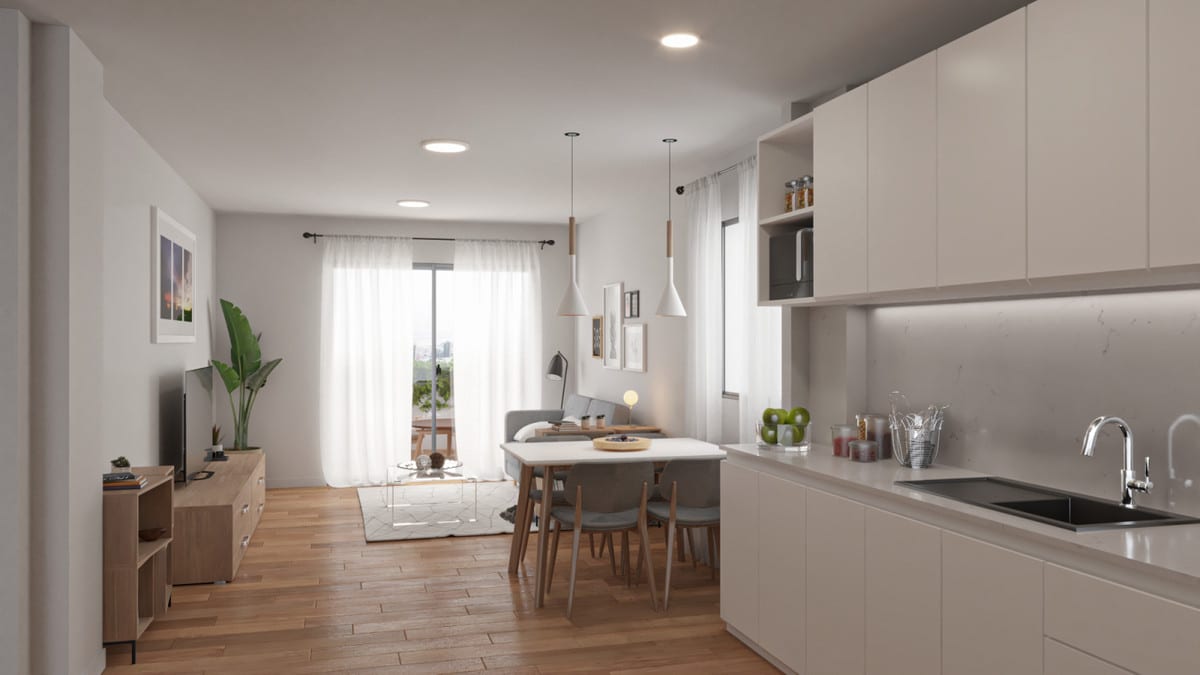 Project visualisation of CORAL MIJAS RESIDENCIAL with an open-plan kitchen with white cabinetry, dining table and chairs, wooden flooring, a seating area with TV unit and a window with white curtains in the background.