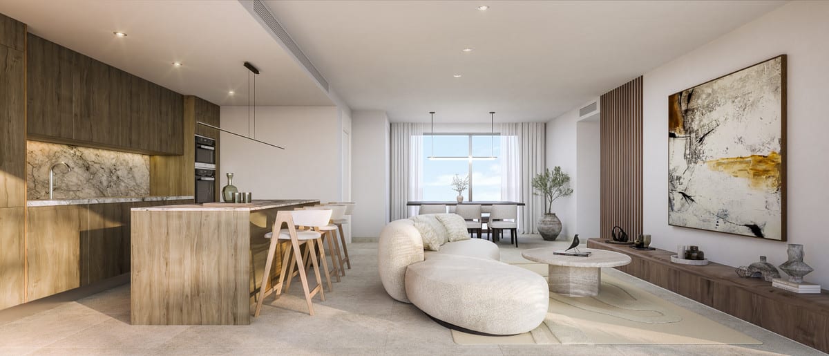 Project visualisation of CORE HIGUERON FASE II featuring an open-plan kitchen with dark wooden cabinetry, a marble-effect splashback, a kitchen island with bar stools and a bright living room with an abstract painting.