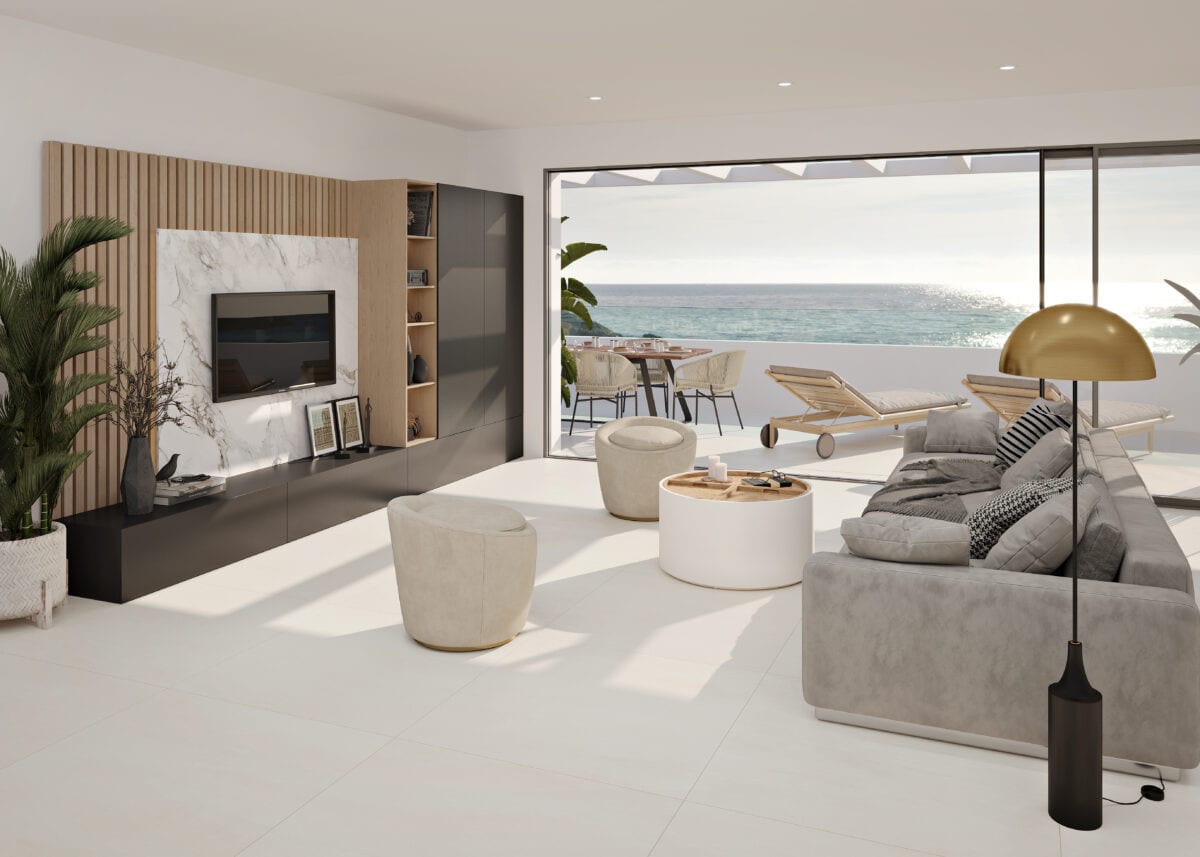 Project visualisation of COSTAFIORE GARDENS - FASE 1 featuring a bright living room, grey sofa, wooden TV wall and open sliding doors to a terrace with sea views.