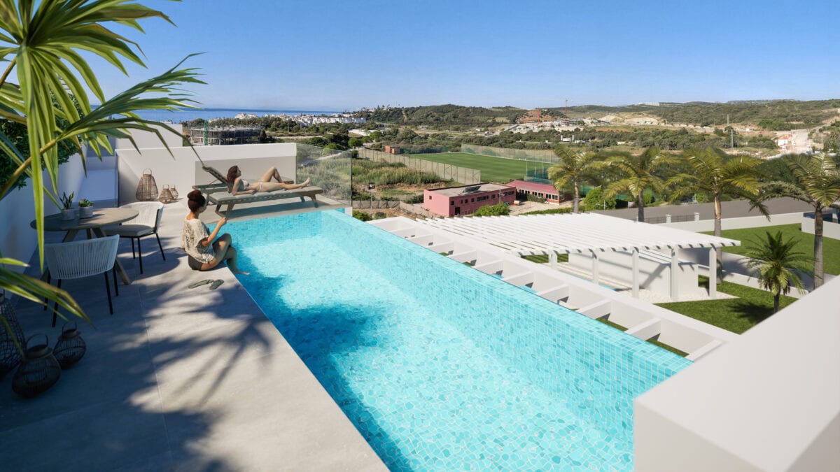 Project visualisation of COSTAFIORE GARDENS - FASE 1 featuring a terrace, turquoise swimming pool, two figures, outdoor seating and a green landscape with coastline in the background.