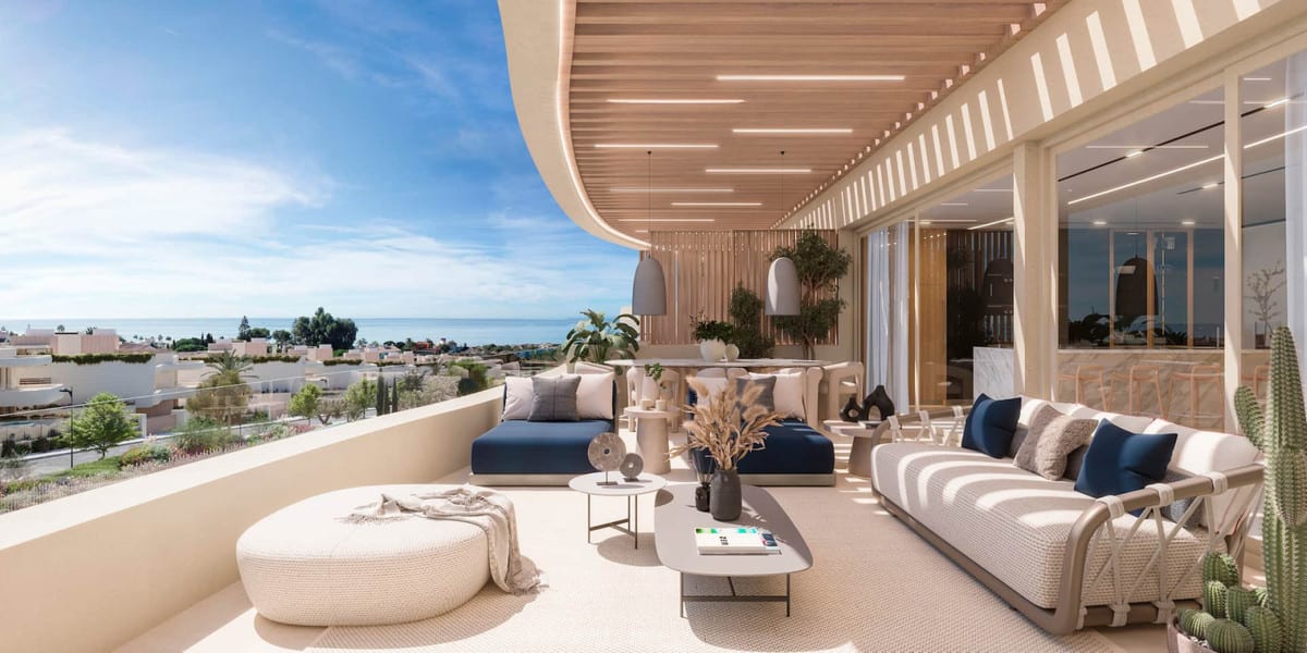 Project visualisation of a furnished terrace at DUNIQUE MARBELLA with a curved canopy, blue and white seating and the sea in the distance.