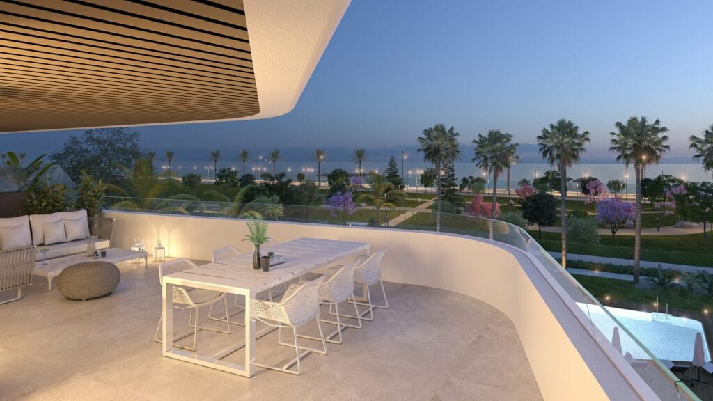 Project visualisation of a spacious terrace at HABITAT ALBORÁN - BORA at dusk, with a white dining table, chairs, seating area, glass balustrade, palm trees and water in the background.