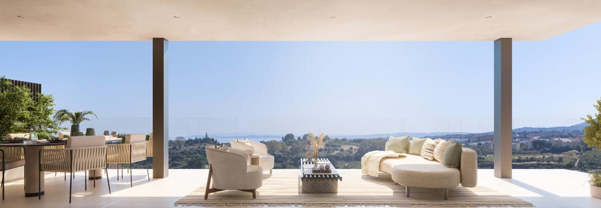 Project visualisation of HAIKU RESIDENCES showing a spacious covered terrace with a dining table, lounge chairs and a sofa between open columns.